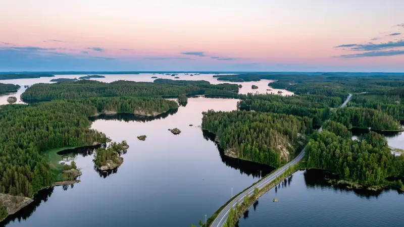 Image of islands, forests and roads under a sunset.