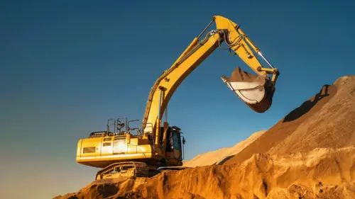 An image of yellow escavator on construction site